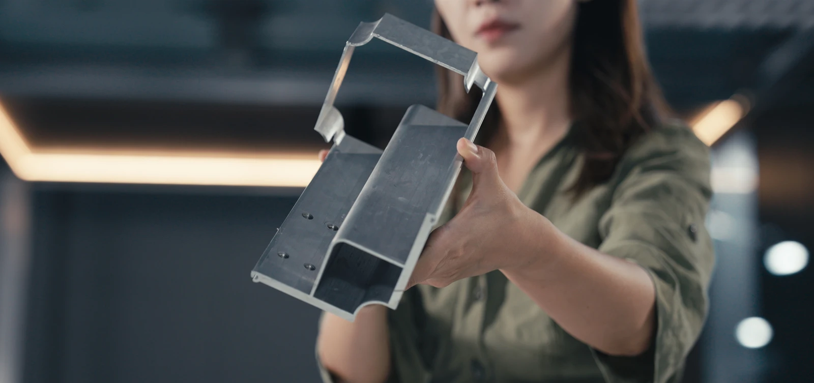 An engineer holding a precision aluminum structural component